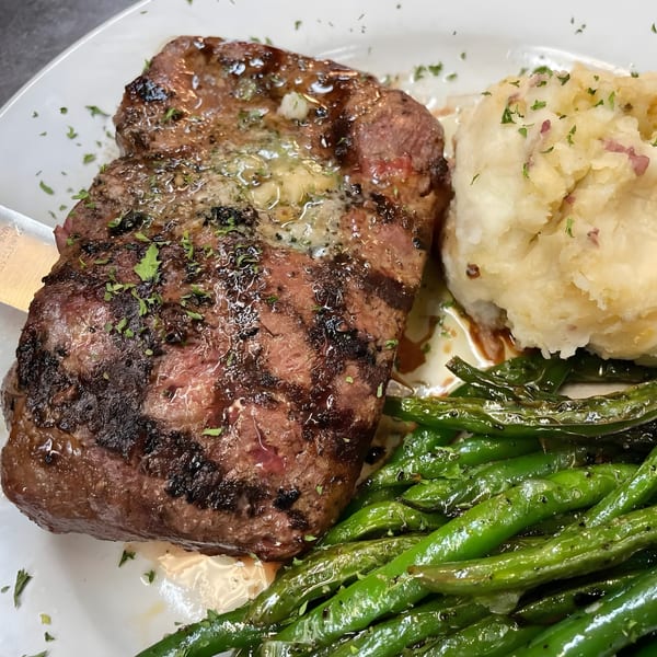 Red Brick Station's grilled steak with melting butter, mashed potatoes, and green beans.